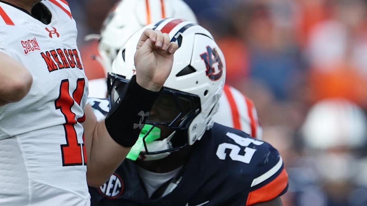  Nov 22, 2025; Auburn, Alabama, USA; Mercer Bears quarterback Braden Atkinson (11) throws a pass as Auburn Tigers defensive end Keyron Crawford (24) closes in during the second quarter at Jordan-Hare Stadium. Mandatory Credit: John Reed-Imagn Images | John Reed-Imagn Images 
