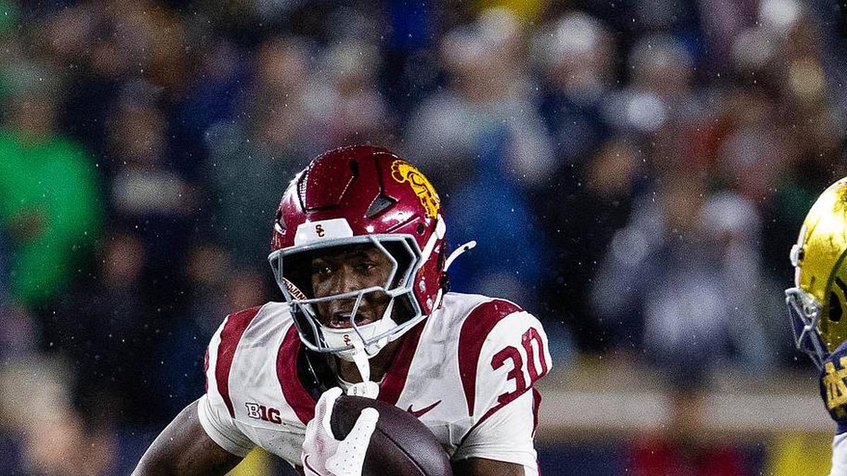  Oct 18, 2025; South Bend, Indiana, USA; Southern California Trojans running back King Miller (30) runs the ball while Notre Dame Fighting Irish safety Tae Johnson (9) defends in the second half at Notre Dame Stadium. Mandatory Credit: Trevor Ruszkowski-Imagn Images | Trevor Ruszkowski-Imagn Images 