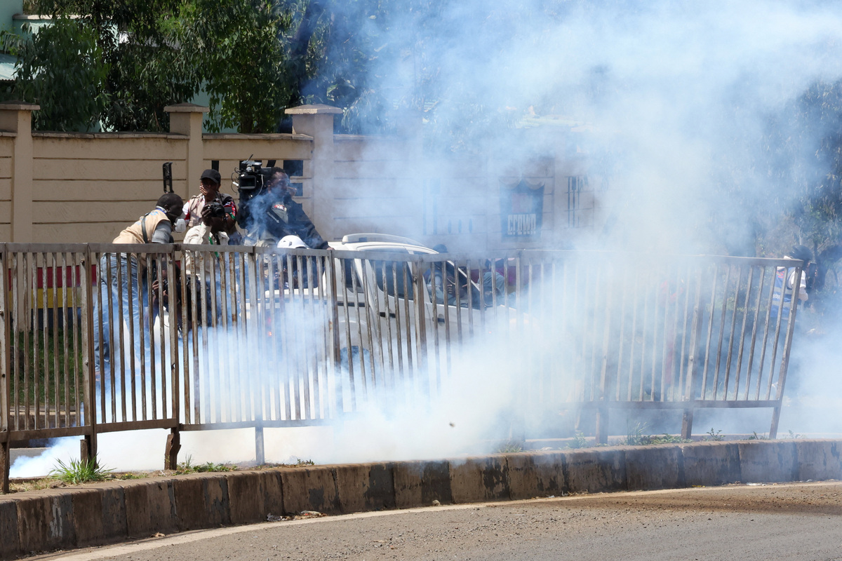 Members of the media work as police officers use tear gas to disperse protesters during demonstrations to mark the second anniversary of the deadly 2024 anti-government protests, in Nairobi, Kenya, June 25, 2026. REUTERS/Monicah Mwangi