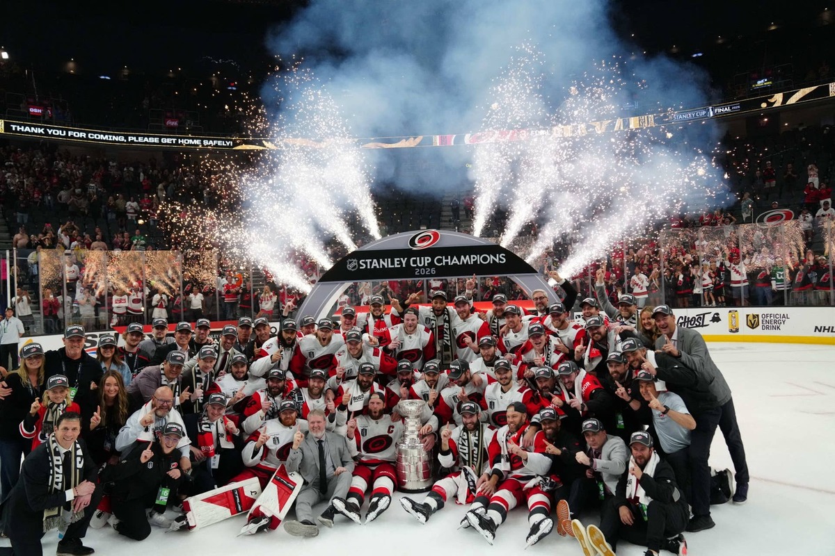  Jun 14, 2026; Las Vegas, Nevada, USA; The Carolina Hurricanes pose with the the Stanley Cup after defeating Vegas Golden Knights in game six of the 2026 Stanley Cup Final at T-Mobile Arena. Mandatory Credit: Stephen R. Sylvanie-Imagn Images
