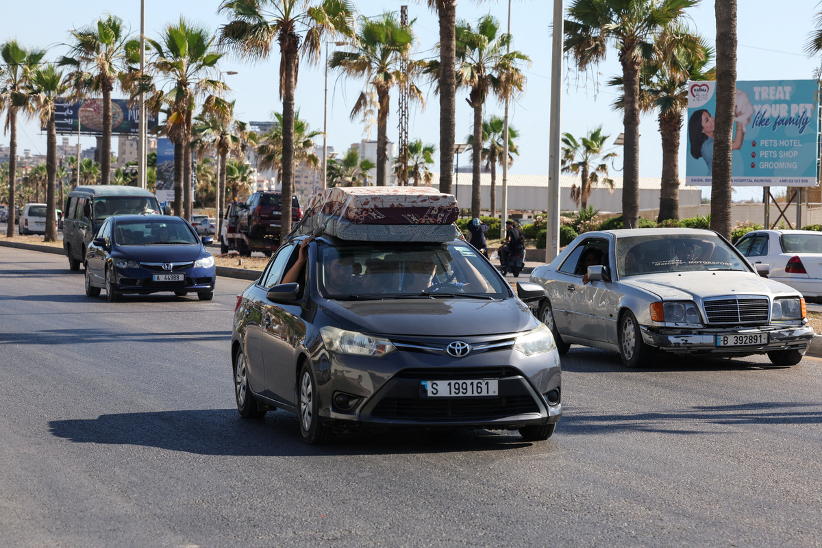 People drive on a car loaded with belongings as they head North, on the outskirts of Sidon, Lebanon, June 19, 2026. REUTERS/Aziz Taher