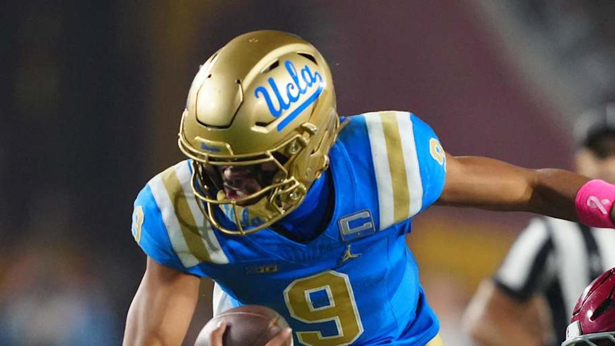  Nov 29, 2025; Los Angeles, California, USA; UCLA Bruins quarterback Nico Iamaleava (9) is tackled by Southern California Trojans linebacker Eric Gentry (18) in the second half at United Airlines Field at Los Angeles Memorial Coliseum. Mandatory Credit: Kirby Lee-Imagn Images | Kirby Lee-Imagn Images 