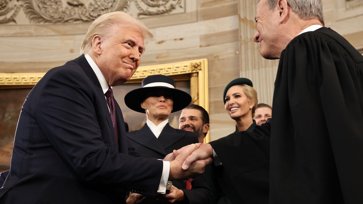 U.S. President Donald Trump shakes hands with U.S. Supreme Court Chief Justice John Roberts (right) as Melania Trump, Donald Trump Jr. and Ivanka Trump look on after Donald Trump was sworn in during inauguration ceremonies in the Rotunda of the U.S. Capitol on Jan. 20, 2025, in Washington, D.C.