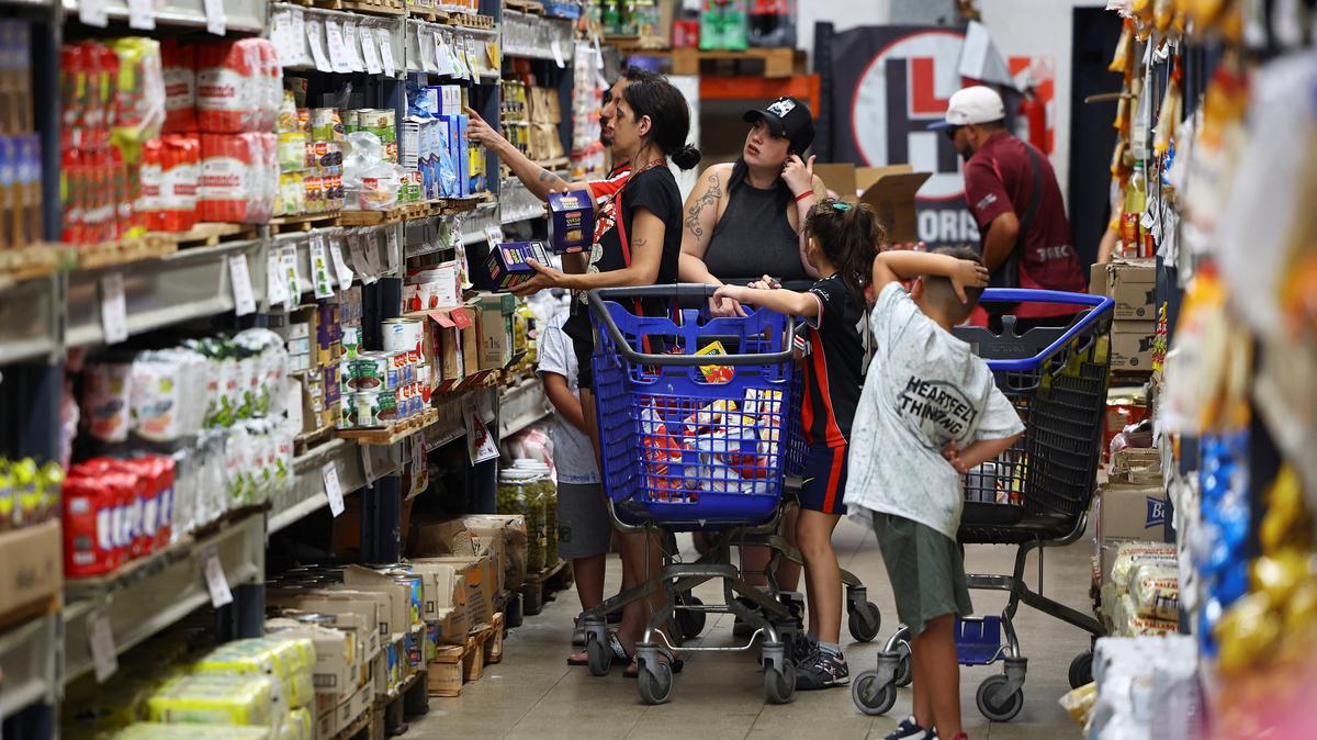 Shoppers check prices at a supermarket in Villa Martelli on the outskirts of Buenos Aires, Argentina January 13, 2026. REUTERS/Agustin Marcarian