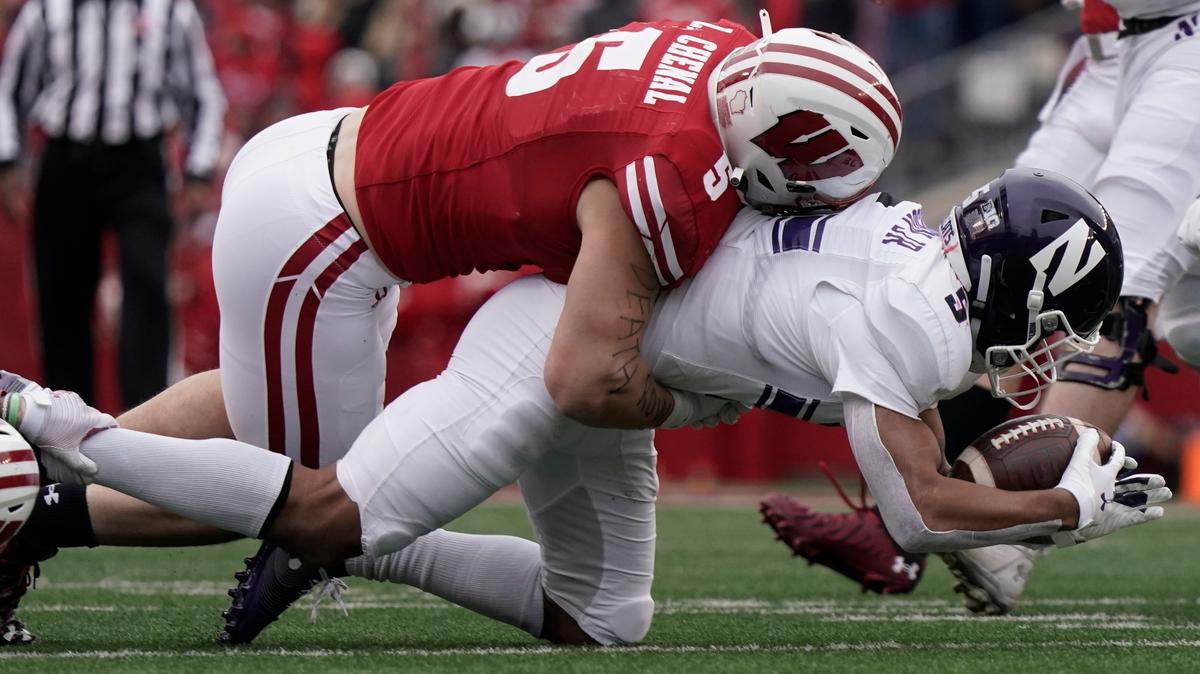Wisconsin’s Leo Chenal stops Northwestern’s Stephon Robinson Jr. for a loss during the first half of an NCAA college football game Saturday, Nov. 13, 2021, in Madison, Wis. (AP Photo/Morry Gash)