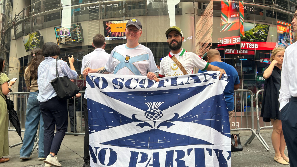 FIFA World Cup 2026 fans pose for pictures outside the Nasdaq stock exchange on the day Elon Musk's rocket company SpaceX goes public at a valuation of $1.75 trillion, in New York, U.S., June 12, 2026. Picture taken with a mobile phone. REUTERS/Joe Brock