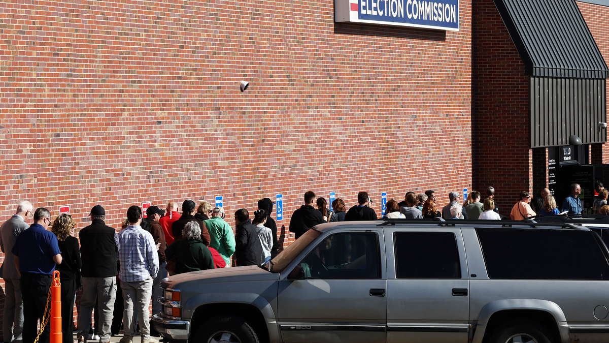 Nebraska’s ‘Blue Dot’ Draws National Attention In Razor-Thin Election. People wait in line to cast early ballots or register to vote outside the Douglas County Election Commission on October 24, 2024 in Omaha, Nebraska.