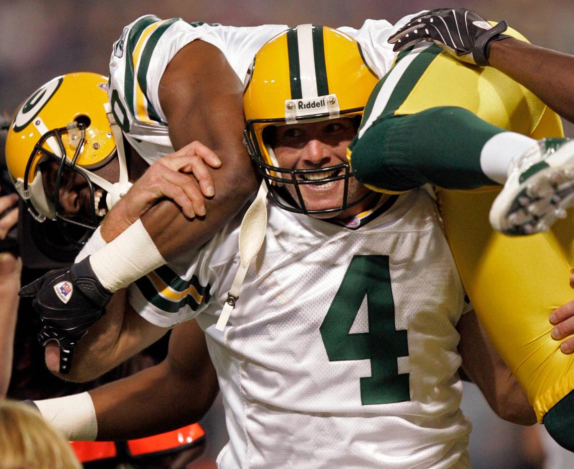  After breaking the NFL record for career touchdown passes in 2007, Packers quarterback Brett Favre hoists its recipient, Greg Jennings. Mark Hoffman / Milwaukee Journal Sentinel / USA TODAY NETWORK via Imagn Images