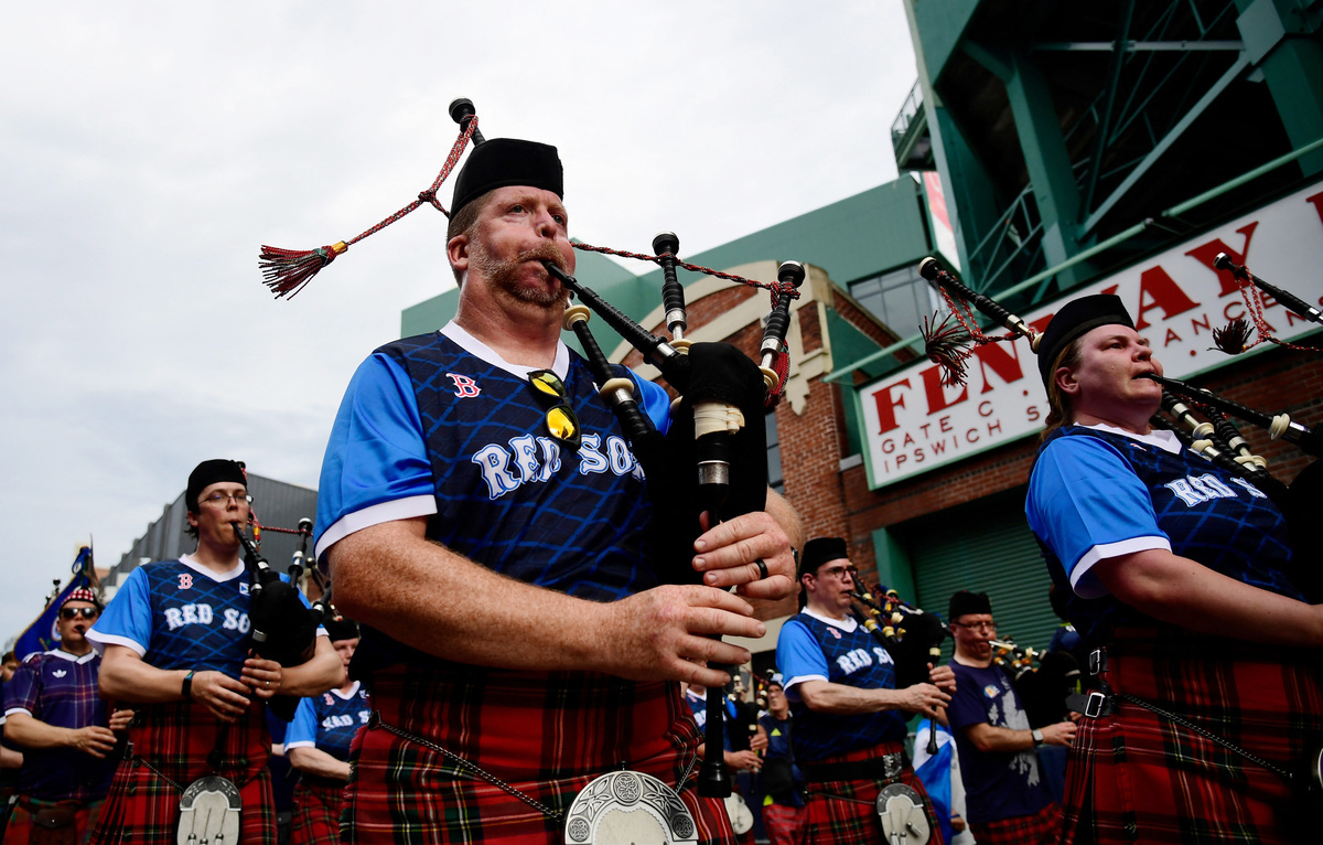 Soccer Football - FIFA World Cup 2026 - Scotland's Tartan Army march to Boston's Fenway Park baseball stadium - Boston, Massachusetts, U.S. - June 14, 2026 Scotland fans wearing kilts and playing the bagpipes during the march to Fenway Park IMAGN IMAGES via Reuters/Bob Dechiara