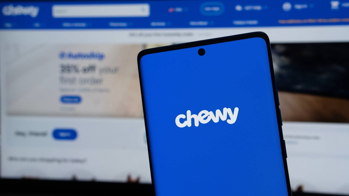 View of chewy.com app open on a smart phone on top of computer keyboard.