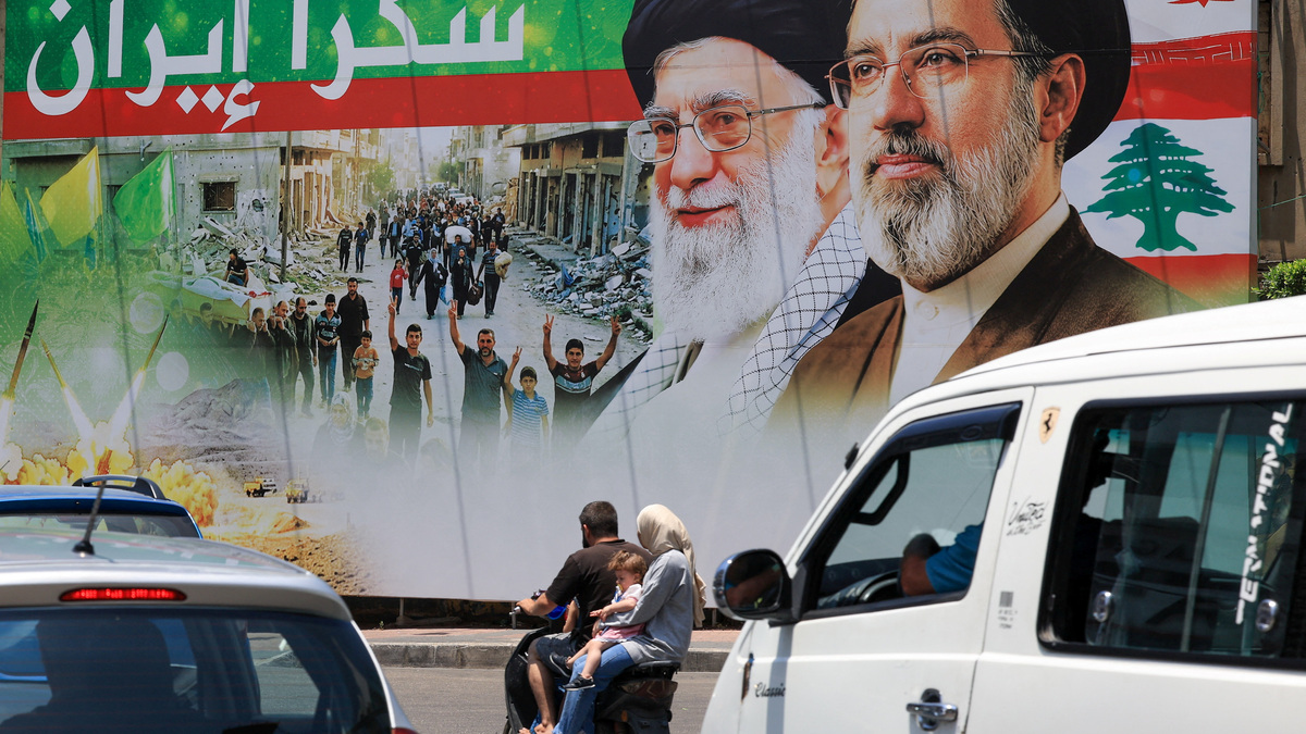 A family ride on a motorcycle past a banner that reads "Thank you Iran" following a deal between the U.S. and Iran, in the southern suburbs of Beirut, Lebanon, June 15, 2026.REUTERS/Mohamed Azakir