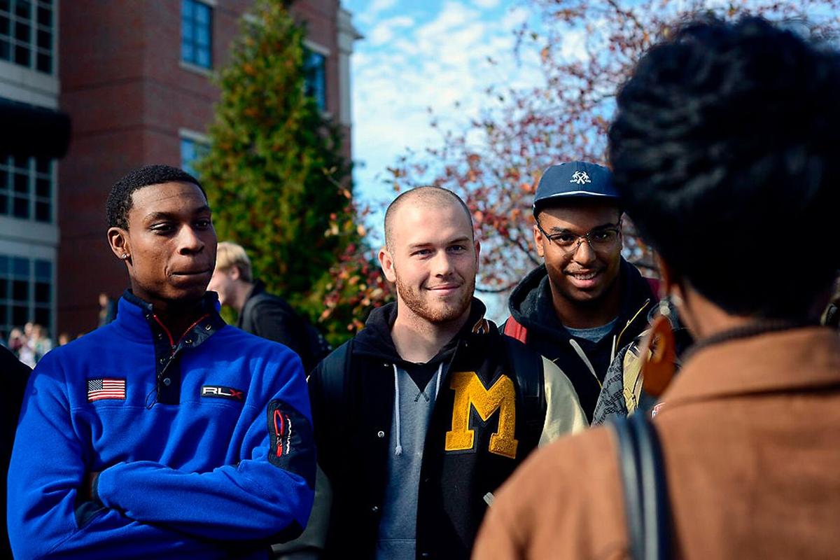 Missouri football players, from left to right, Keyon Dilosa, Jake Hurrell and Marcell Frazier tell a reporter they cannot comment on Nov. 9, 2015, at Mel Carnahan Quadrangle on campus. Black members of the Missouri football team announced Saturday that they would boycott all athletic participation until then-UM System President Tim Wolfe resigned.