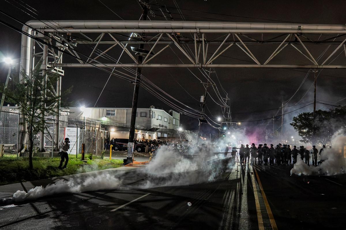New Jersey State Policemen stand guard near the deployed tear gas as protestors remain gathered outside Delaney Hall detention center, in Newark, New Jersey, U.S., May 29, 2026. REUTERS/David Delgado