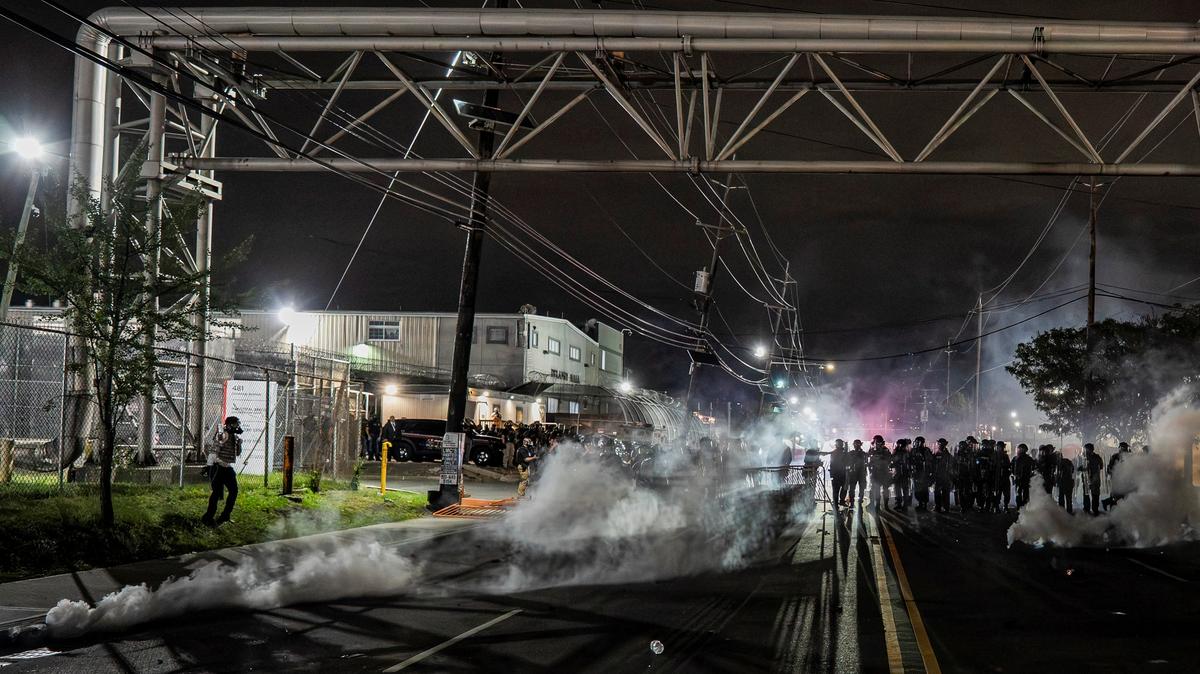 New Jersey State Policemen stand guard near the deployed tear gas as protestors remain gathered outside Delaney Hall detention center, in Newark, New Jersey, U.S., May 29, 2026. REUTERS/David Delgado