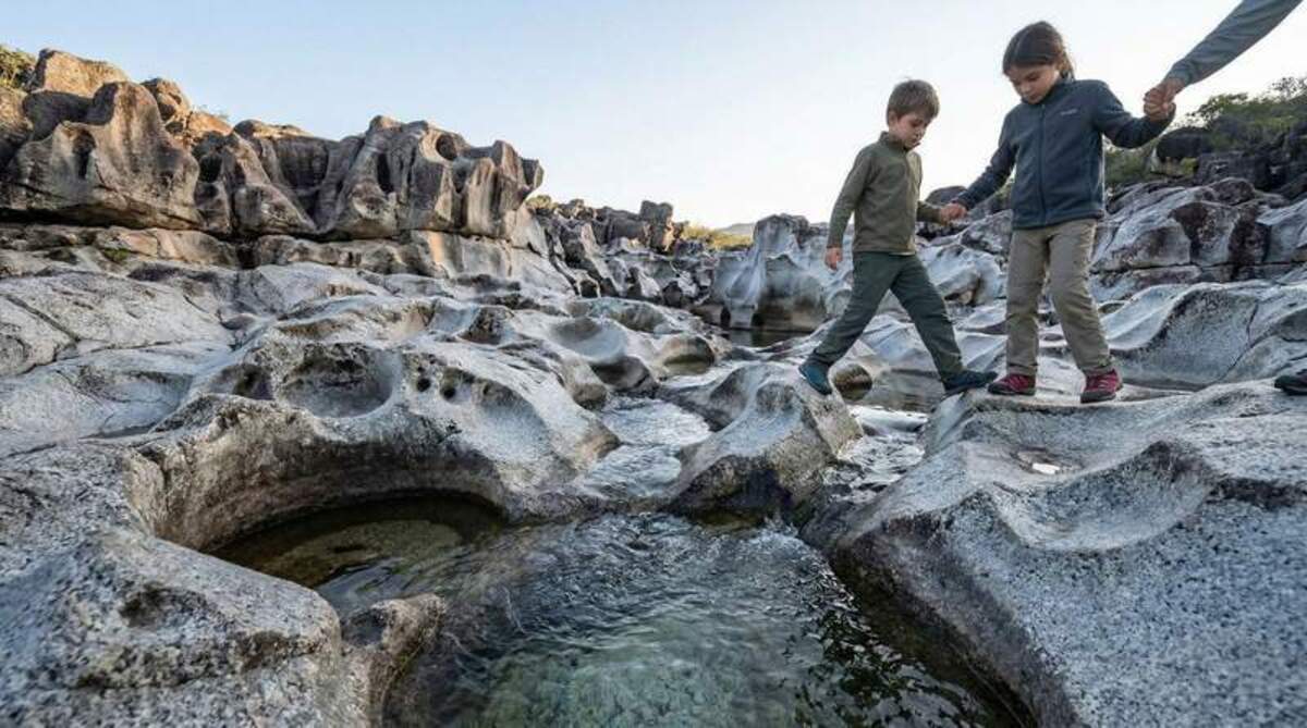  Houston, we have a waterfall. Walking through these silver craters feels more like a lunar mission than a hike. It's the only place on Earth where your kids can moonwalk through natural granite jacuzzis. Photo credit: Felipe and Melissa Machado TripVista360 