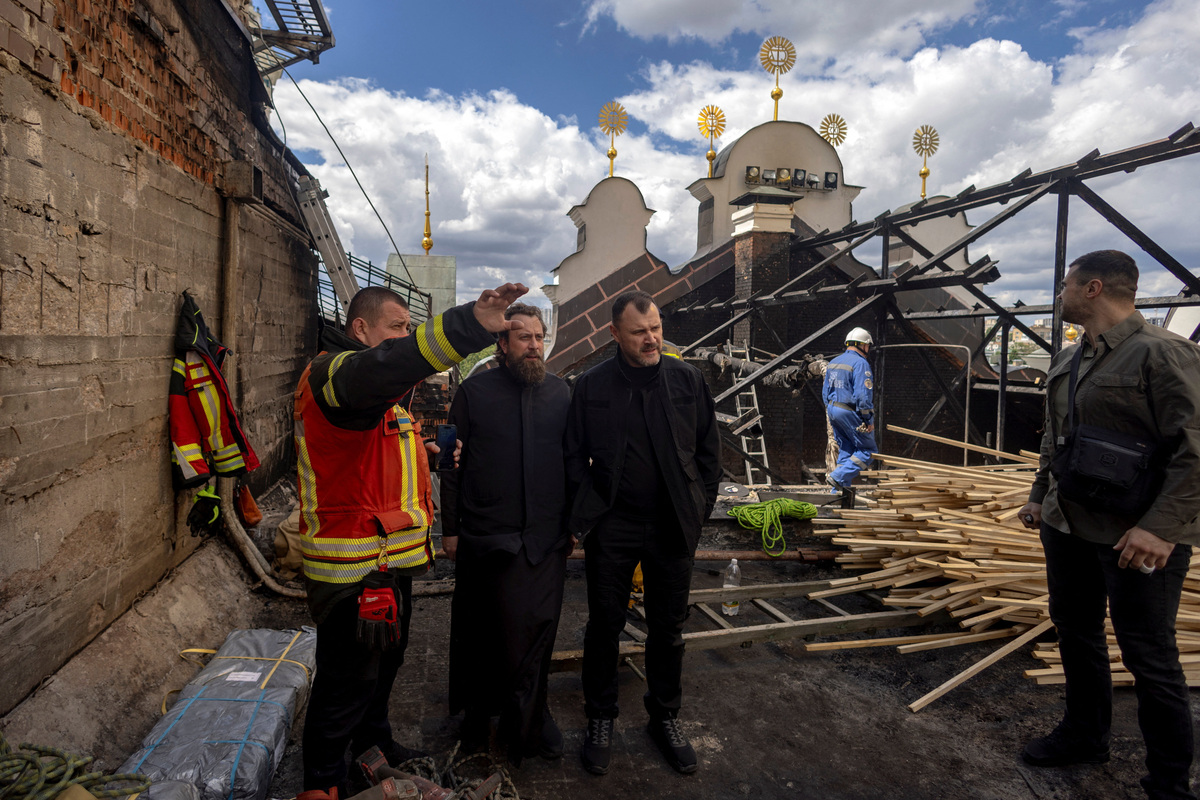 Ukrainian Minister of Internal Affairs Ihor Klymenko inspects the roof the Dormition Cathedral of the Kyiv Pechersk Lavra, after it was hit during yesterday’s Russian missile and drone strikes, amid Russia's attack on Ukraine, in Kyiv, Ukraine June 16, 2026.  REUTERS/Thomas Peter