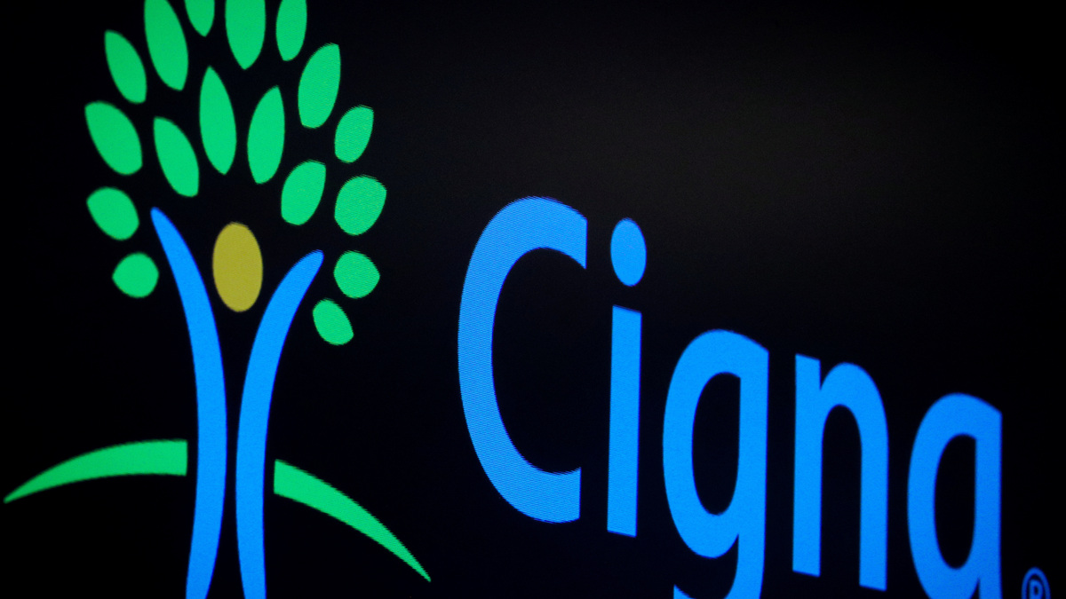 A screen displays the logo for Cigna Corp. on the floor at the New York Stock Exchange (NYSE) in New York, U.S., July 16, 2019. REUTERS/Brendan McDermid