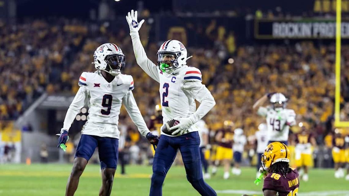  Nov 28, 2025; Tempe, Arizona, USA; Arizona Wildcats defensive back Treydan Stukes (2) celebrates with defensive back Ayden Garnes (9) after an interception against Arizona State Sun Devils in the second half during the 99th Territorial Cup at Mountain America Stadium. Mandatory Credit: Mark J. Rebilas-Imagn Images | Mark J. Rebilas-Imagn Images 
