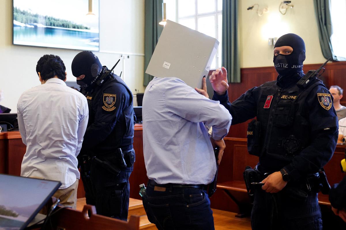 Austrian defendant identified as Beran A, suspected of planning an attack on U.S. singer Taylor Swift's Vienna concert in 2024, is escorted by security personnel in a courtroom for his trial in Wiener Neustadt, Austria, May 28, 2026. REUTERS/Lisa Leutner