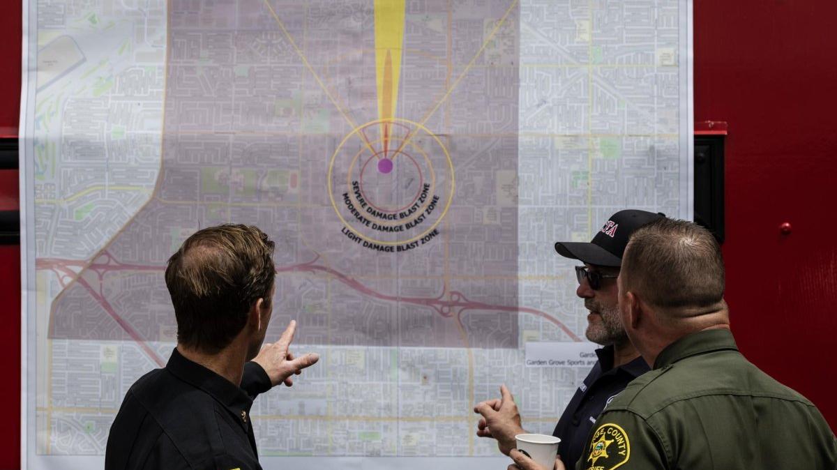 Fire and police officials look at a map of the chemical plant after a leak from a large storage tank at the GKN Aerospace facility in Garden Grove, Calif., Saturday. A failing 34,000-gallon tank of methyl methacrylate overheated, but the danger of explosion is over. Photo by Ted Soqui/EPA