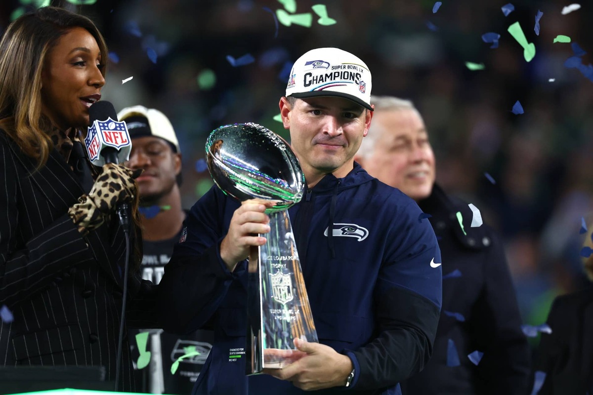  Feb 8, 2026; Santa Clara, CA, USA; Seattle Seahawks head coach Mike MacDonald celebrates with the Vince Lombardi trophy on the podium after defeating the New England Patriots in Super Bowl LX at Levi's Stadium. Mandatory Credit: Mark J. Rebilas-Imagn Images 