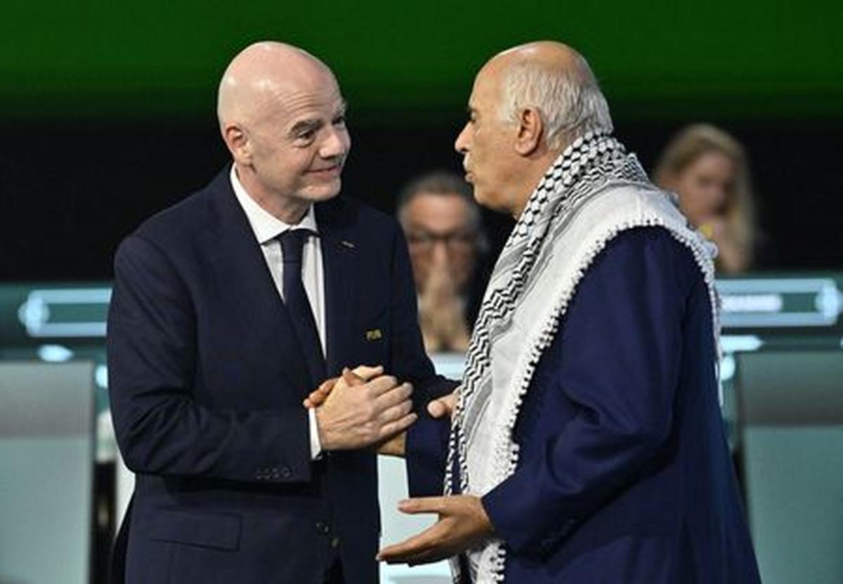 Soccer Football - 76th FIFA Congress - Vancouver Convention Centre, Vancouver, Canada - April 30, 2026  FIFA President Gianni Infantino shakes hands with Jibril Rajoub, President of the Palestine Football association during the congress REUTERS/Jennifer Gauthier