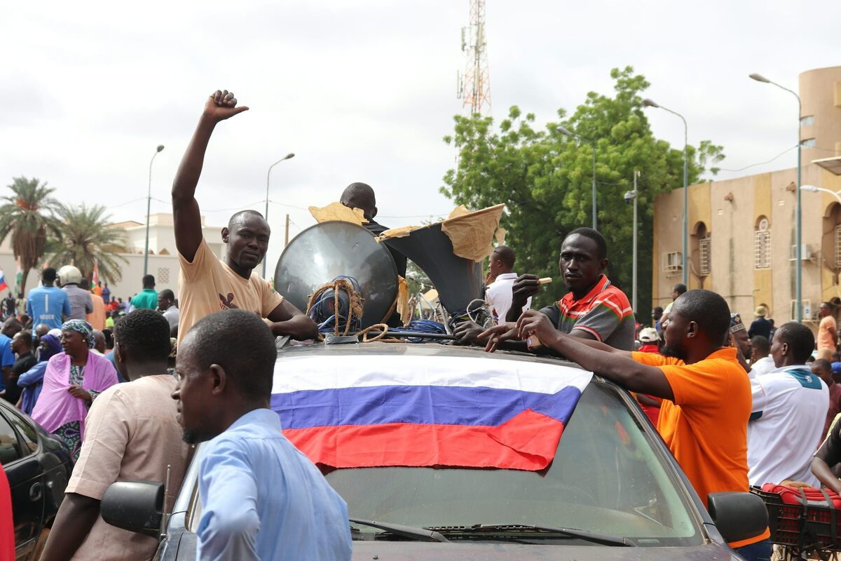  Nigeriens in the country's capital, Niamey, display Russian flags during a pro-coup protest in 2023. Djibo Issifou/Picture Alliance via Getty Images 