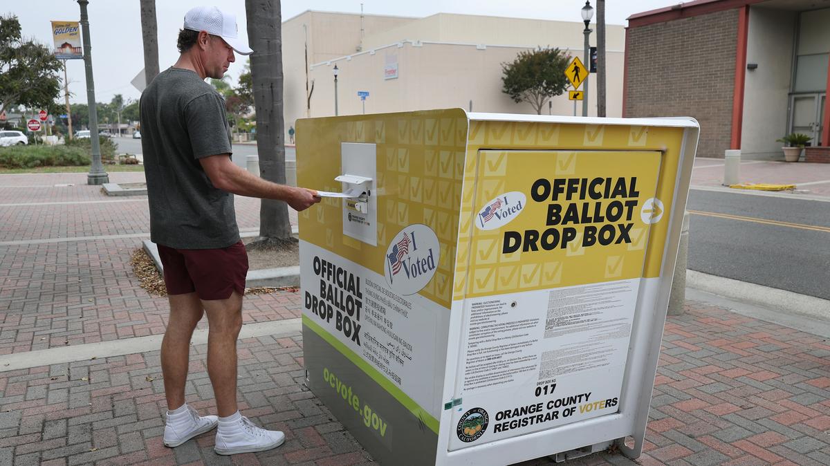 Garrett Morgan, of Huntington Beach, California, puts his ballot in the official ballot drop box on Main Street in downtown Huntington Beach on Oct. 25, 2025. (Allen J. Schaben/Los Angeles Times/TNS)