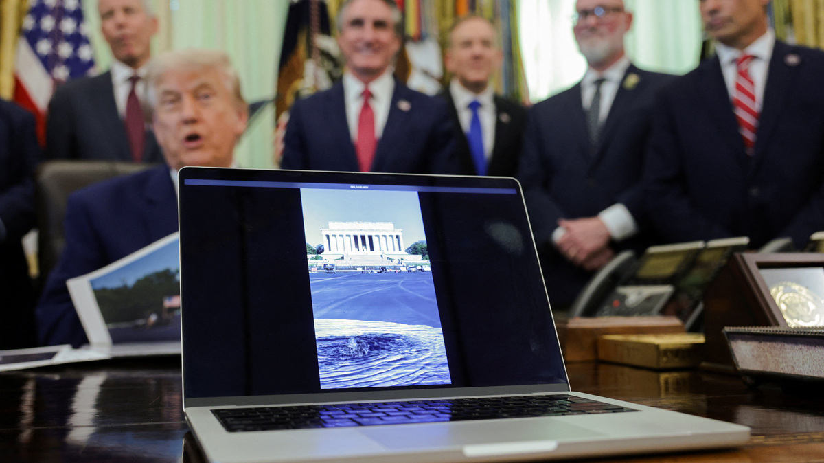 A video showing water filling the Lincoln Reflecting Pool plays as President Donald Trump delivers remarks to reporters in the Oval Office at the White House in Washington on Thursday.