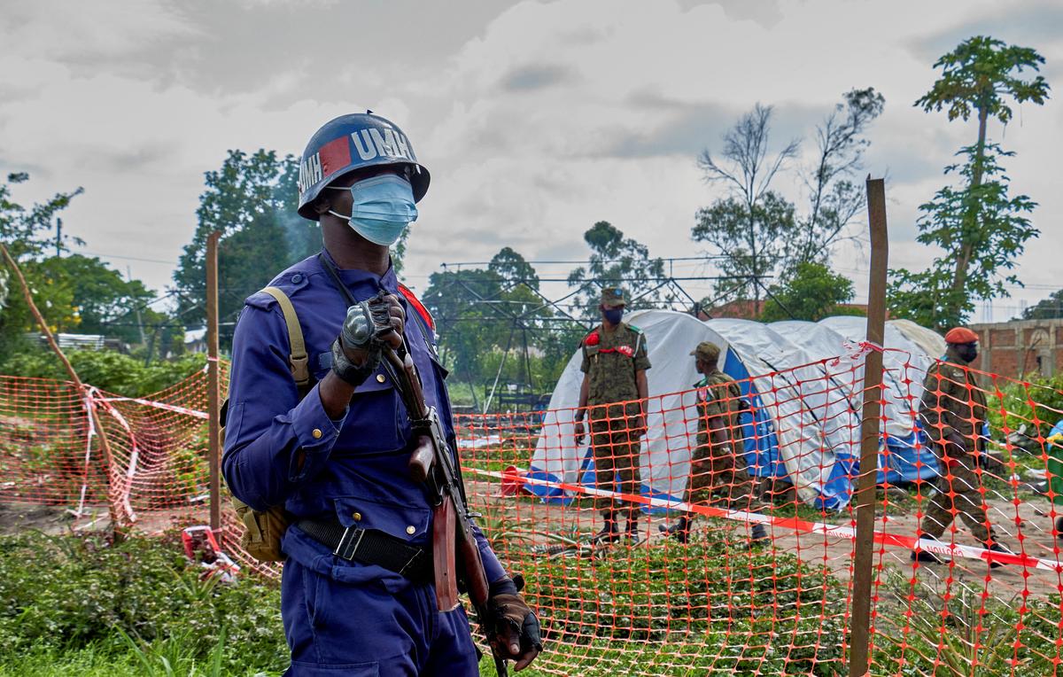 A Congolese police officer and soldiers stand at the burnt Ebola treatment center, as aid agencies intensify efforts to contain a new Ebola outbreak involving the Bundibugyo strain, in Rwampara general hospital in Rwampara outside Bunia, Ituri province, Democratic Republic of Congo, May 21, 2026. REUTERS/Gradel Muyisa Mumbere