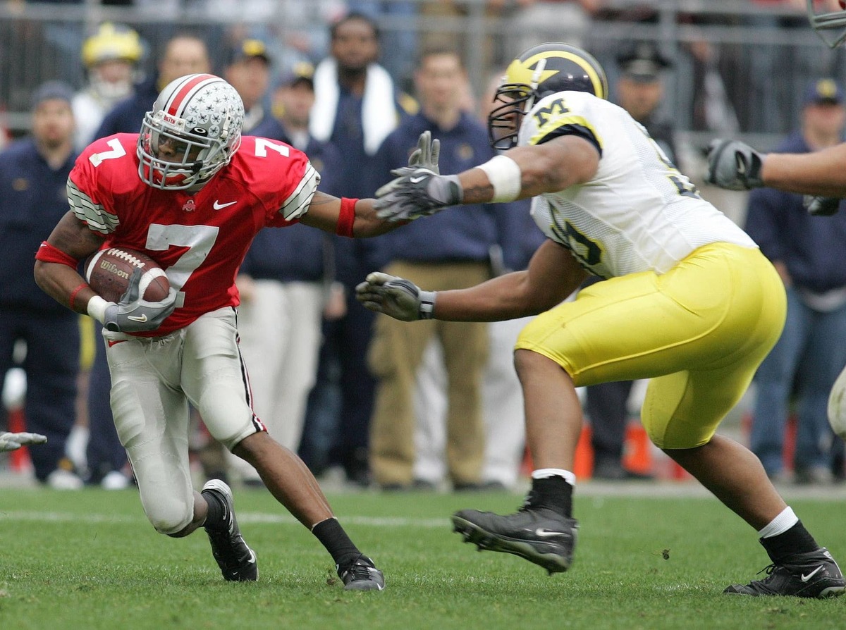  Ohio State Buckeyes #7 Ted Ginn Jr. tries to stiff arm Michigan Wolverines #56 LaMarr Woodley at Ohio Stadium. Matthew Emmons-USA TODAY Sports