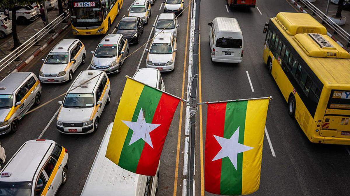 Myanmar flags line a road near Sule Pagoda on January 26, 2026 in Yangon.
