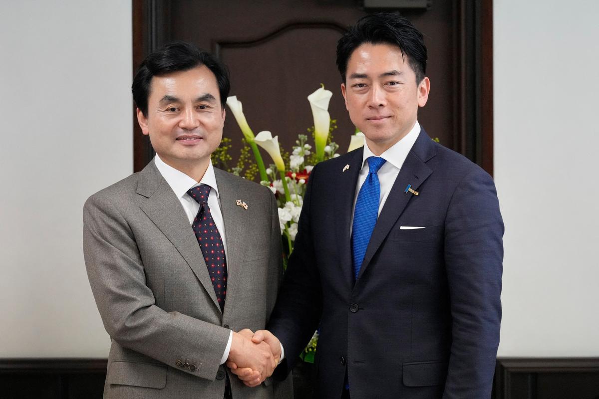 Japan's Defense Minister Shinjiro Koizumi and South Korea's Defense Minister Ahn Gyu-back shake hands prior to their meeting at the headquarters of the Japan Maritime Self-Defense Force, in Yokosuka District, Tokyo, January 30, 2026.     Eugene Hoshiko/Pool via REUTERS