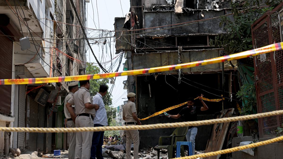 Police officers stand at the site a day after a fire at a hotel in New Delhi, India, June 4, 2026. REUTERS/Bhawika Chhabra