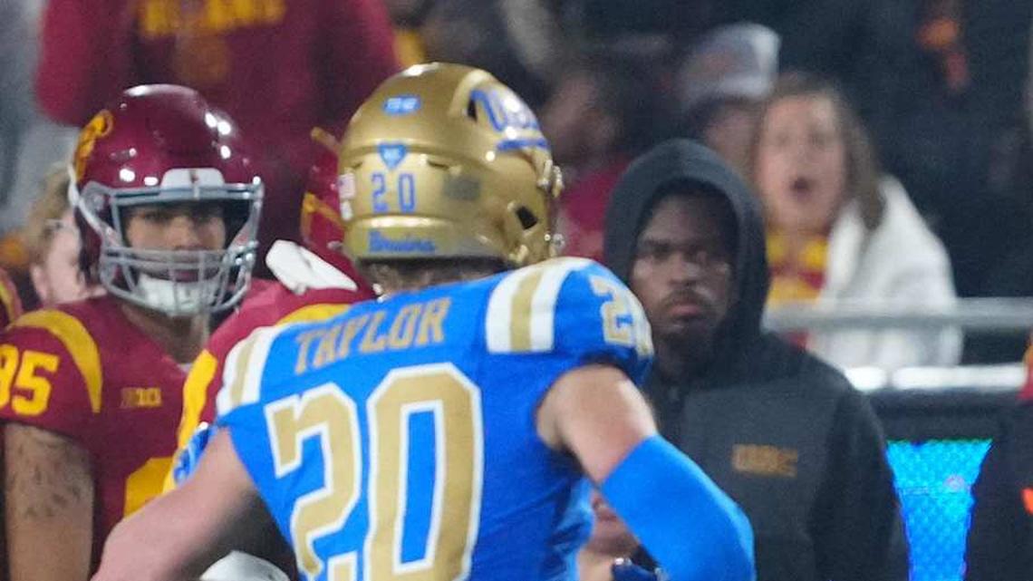  Nov 29, 2025; Los Angeles, California, USA; Southern California Trojans wide receiver Makai Lemon (6) hurdles UCLA Bruins punter Will Karoll (49) as linebacker Scott Taylor (20) watches in the second half at United Airlines Field at Los Angeles Memorial Coliseum. Mandatory Credit: Kirby Lee-Imagn Images | Kirby Lee-Imagn Images 