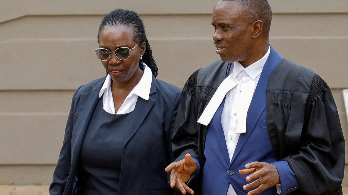 Uganda's veteran opposition figure Kizza Besigye's lawyers, Erias Lukwago, and Martha Karua walk after a court proceeding at the High Court in Kampala, Uganda, June 11, 2026. REUTERS/Abubaker Lubowa