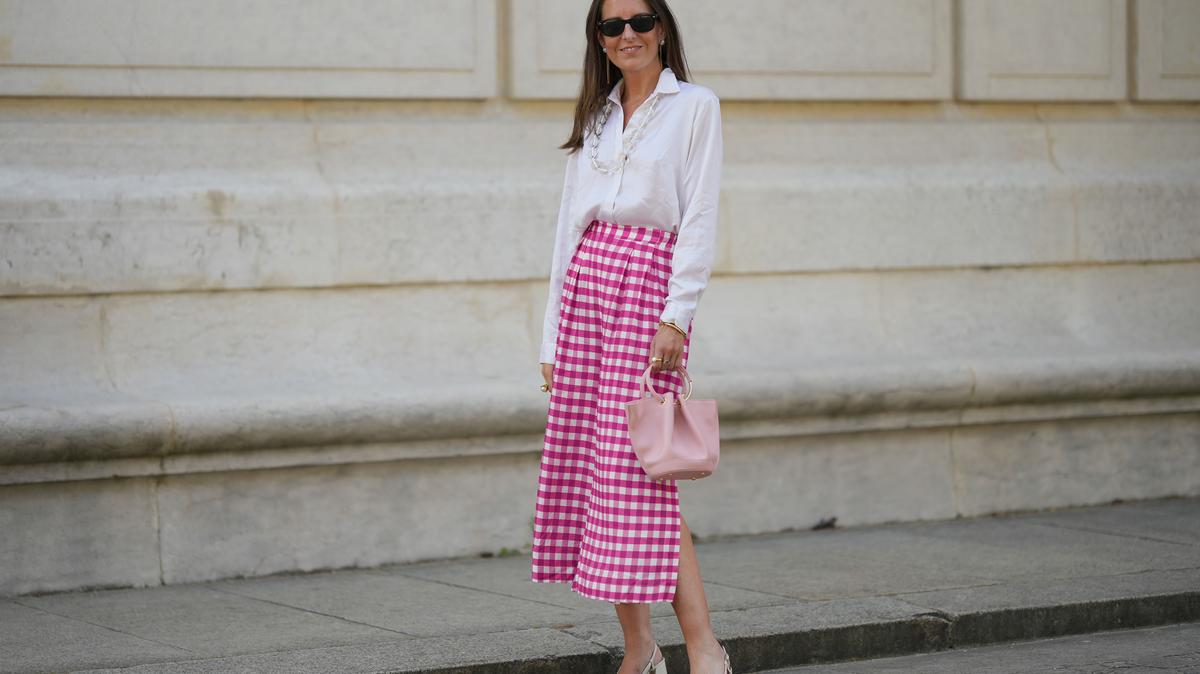 PARIS, FRANCE - JUNE 06: Alba Garavito Torre wears black sunglasses from Ray Ban, white pearl and gold chain pendant earrings, a transparent large pearls long necklace, a white shirt, pink and white checkered print pattern midi pants from Frambuã, gold bracelets, a pale pink matte leather handbag from Saonara Brand, white latte matte shiny leather block heels mules from Jonak, during a street style fashion photo session, on June 06, 2023 in Paris, France. (Photo by Edward Berthelot/Getty Images)