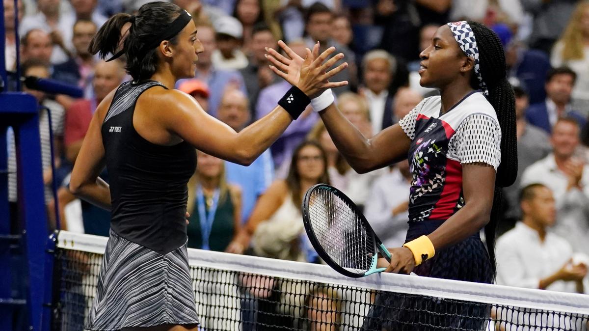 Caroline Garcia, of France, left, shakes hands with Coco Gauff, of the United States, after a quarterfinal of the U.S. Open tennis championships, Tuesday, Sept. 6, 2022, in New York. Garcia won the match. (AP Photo/Charles Krupa)