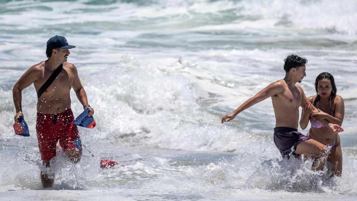 A lifeguard directs a pair of swimmers out of a riptide zone at Thousand Steps Beach in Laguna Beach on Saturday, June 20, 2026. (Photo by Jeff Antenore, Orange County Register/SCNG)