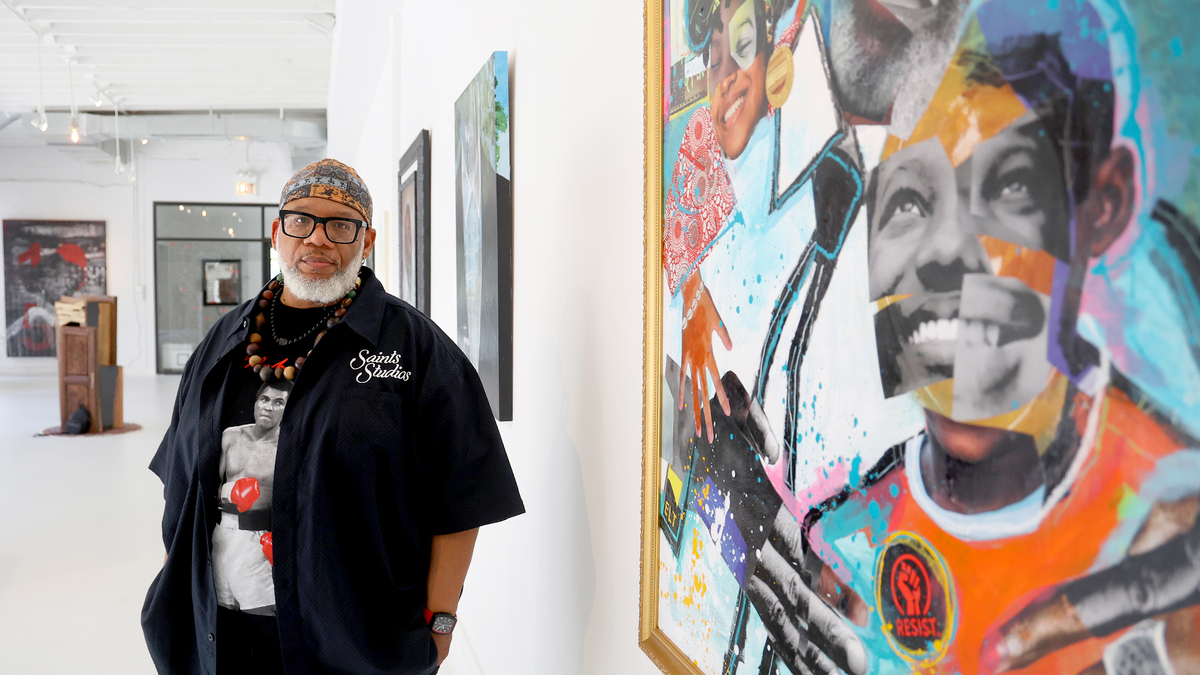 Artist Raymond A. Thomas stands near his paintings, “We Love You Paw Paw,” right, at the Blanc Gallery in Chicago on June 3, 2026. The Blanc Gallery, in partnership with the Emmett Till-Mobley Institute, is holding "From Memory to Movement: Emmett at 85," a group art exhibition commemorating what would have been the 85th birthday of Emmett Till.