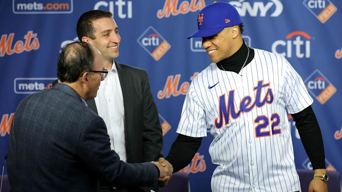  New York Mets right fielder Juan Soto shakes hands with team owner Steve Cohen in front of general manager David Stearns during a press conference at Citi Field | Brad Penner-Imagn Images 