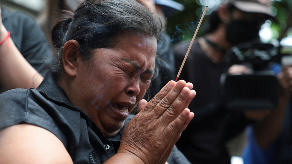 Mother of the victim, Kanokthip Srisuk, visits Rong Beer Na Lat Phrao bar, the site of a deadly fire, to pay tribute to Srisuk and other victims who lost their lives in the bar fire, the day after the incident, in Bangkok, Thailand, July 14, 2026. REUTERS/Chalinee Thirasupa