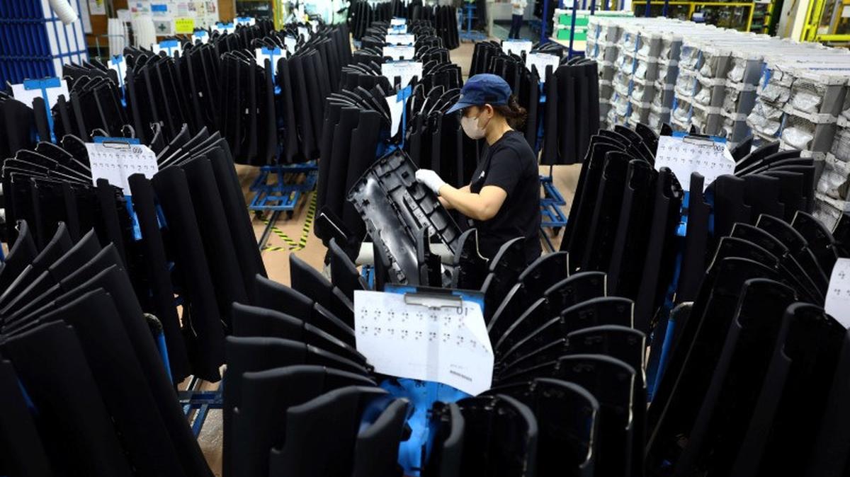 An employee works on the assembly line at Nanjo Auto Interior, a manufacturer of inside door panels and other parts for Mazda Motor, in Akitakata, Hiroshima Prefecture, Japan July 14, 2025.  REUTERS/Issei Kato