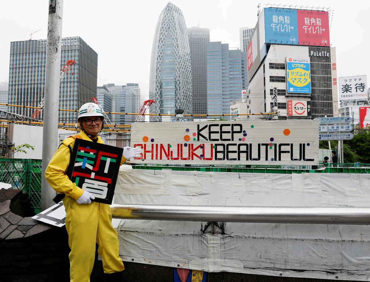 Shuetsu Sato, a security guard whose handmade duct-tape signs have gained widespread recognition, poses with duct-tape signs he made outside Shinjuku Station's east exit in Tokyo, Japan, May 1, 2026. REUTERS/Kim Kyung-Hoon