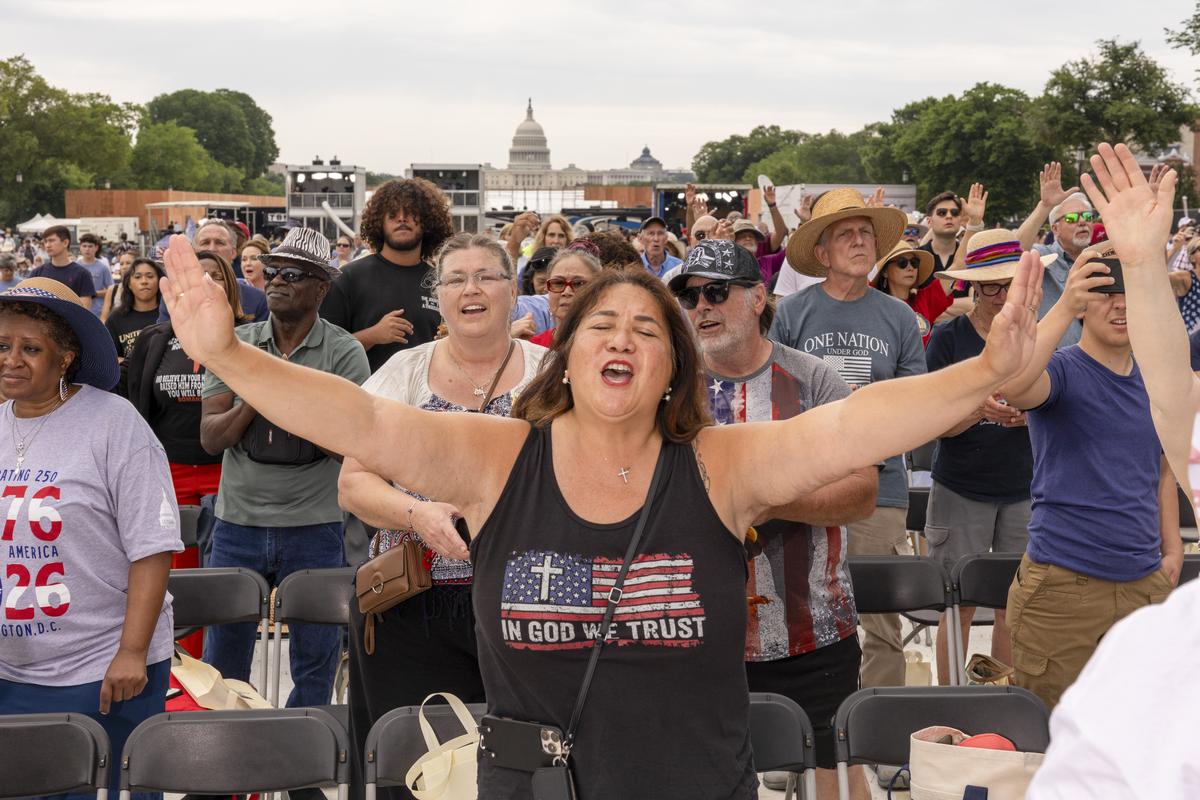 NYTSELECTS -- Attendees raise their hands in worship during Rededicate 250: A National Jubilee of Prayer, Praise & Thanksgiving, in Washington on Sunday, May 17, 2026. Thousands of people gathered on the National Mall on Sunday for a daylong rally blending Christian prayer and political fervor, a gathering President Donald Trump had touted as an opportunity to "rededicate America as one nation under God." (Alex Kent/The New York Times)