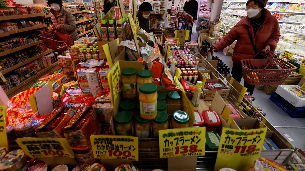 Shoppers check food items at a supermarket in Tokyo, Japan January 20, 2023. REUTERS/Issei Kato
