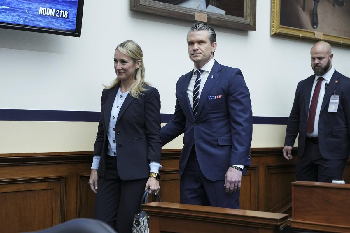 Defense Secretary Pete Hegseth walks with his wife, Jennifer Hegseth, as he returns from a recess in a House Armed Services Committee hearing on the Department of Defense's budget request on Capitol Hill in Washington, on Wednesday, April 29, 2026. (Haiyun Jiang/The New York Times)