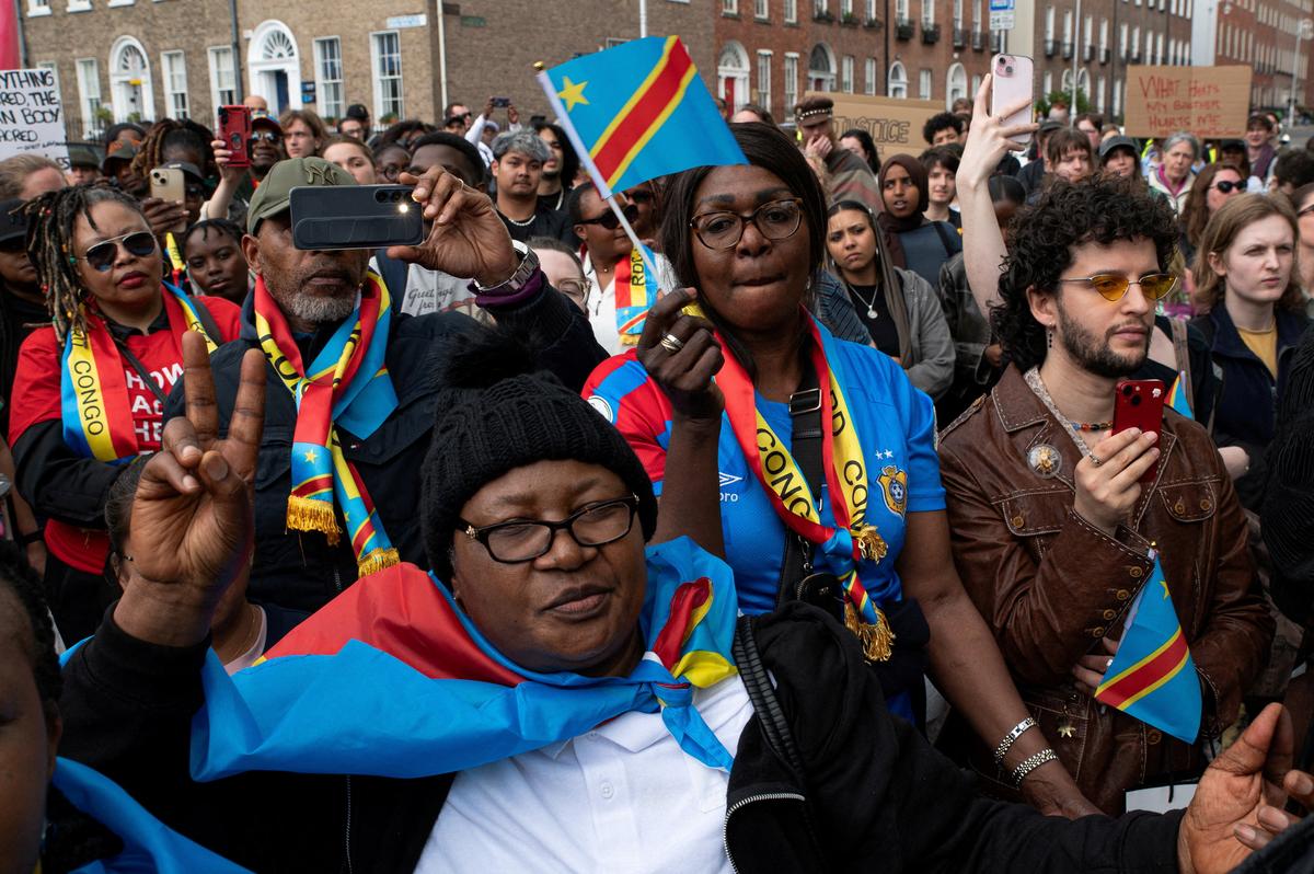 People hold flags during a protest following the death of Yves Sakila, a Congolese-born man who died after being restrained by security guards outside a department store, outside Leinster House in Dublin, Ireland, May 21, 2026. REUTERS/Natalia Campos