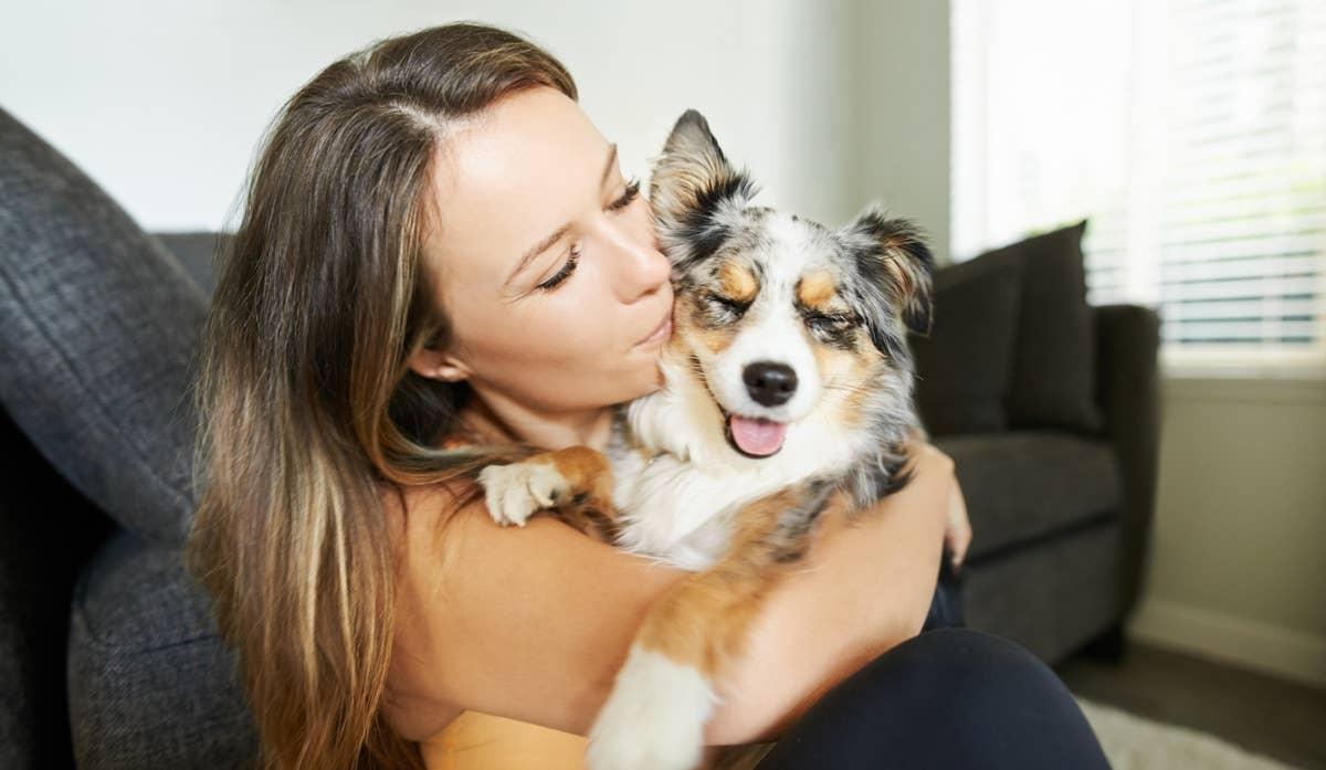  A pet parent kissing her pup who has a popular dog name.