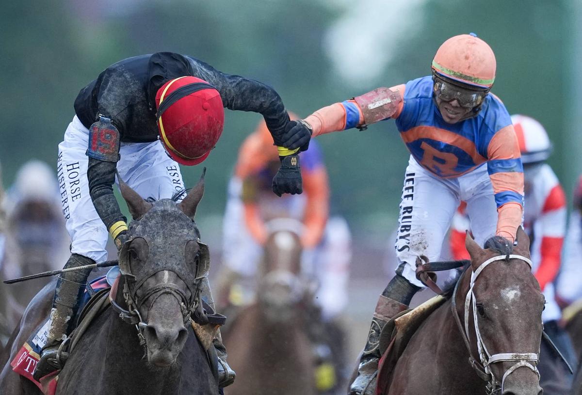  2026 Kentucky Derby winning Golden Tempo jockey Jose Ortiz, left, reaches to receive congratulations from his brother Irad Ortiz after Golden Tempo won the Derby. Irad Ortiz was on second-place Renegade. It was Jose Ortiz's first Kentucky Derby win. May 2, 2026. 